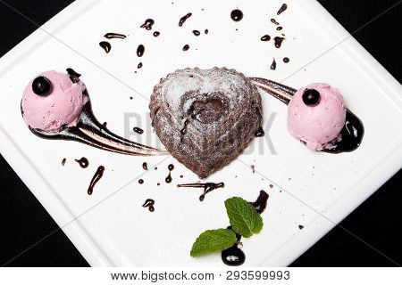 Dessert Fondan Chocolate With Ice-cream On A White Plate On A Black Background. Exquisite French Cho