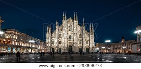 Milan Cathedral or Duomo di Milano at night, Italy. It is a top landmark of the Milan city. Old Gothic architecture of Milan in evening. Panorama of the main Milan square with people at dusk.