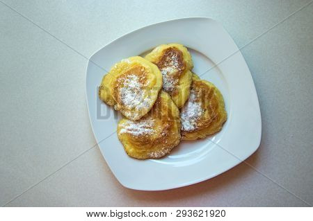 Traditional Polish Pancakes On A Plate - Sweet Pancakes Sprinkled With Powdered Sugar
