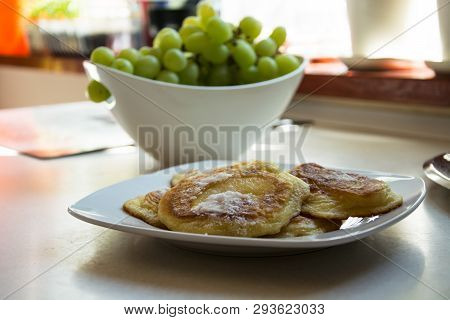 Traditional Polish Pancakes On A White Plate And Green Grapes On A Kitchen Counter - Sweet Pancakes 