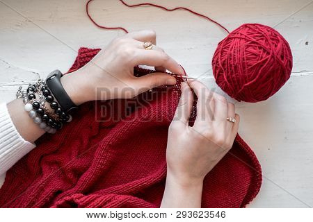 All For Needlework: Red Thread, Knitting, Knitting Needles On A Wooden Gray Table. Top View. Lose-up