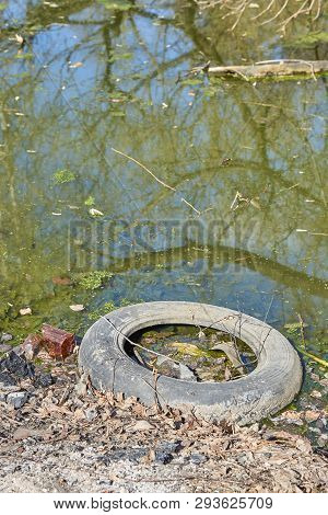 Garbage Thrown To The Bank Of The River, The Topic Of Environmental Pollution