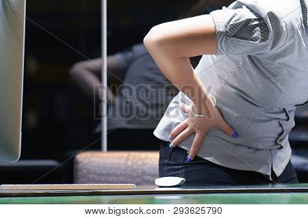 Close-up View Of Office Worker Woman With Pain In Kidneys. Woman With Back Ache Clasping Her Hand To