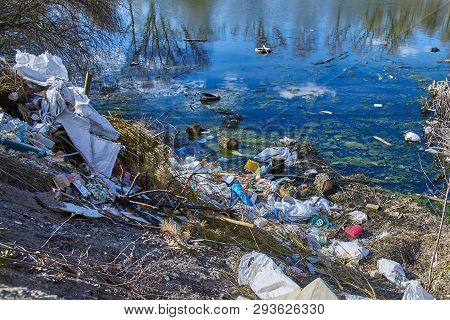 Garbage Thrown To The Bank Of The River, The Topic Of Environmental Pollution