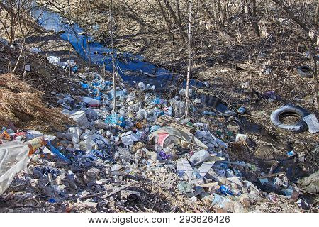 Garbage Thrown To The Bank Of The River, The Topic Of Environmental Pollution