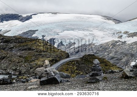 View Of A Road From Dalsnibba Viewpoint View A Huge Glacier In The Background And Rock Formations In