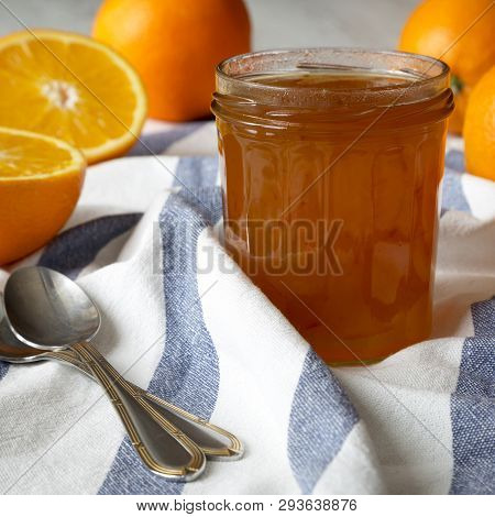 Homemade Orange Jam In Glass Jar, Side View. Closeup.