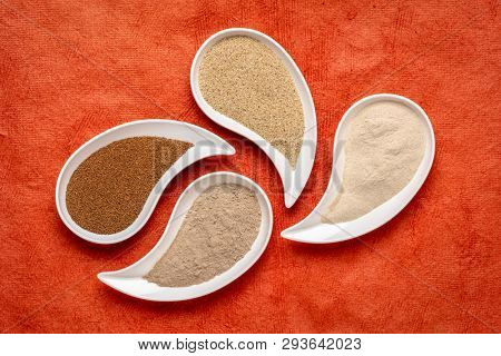 gluten free brown and ivory teff grain and flour on teardrop shaped bowls against red textured paper - important food grain in Ethiopia and Eritrea