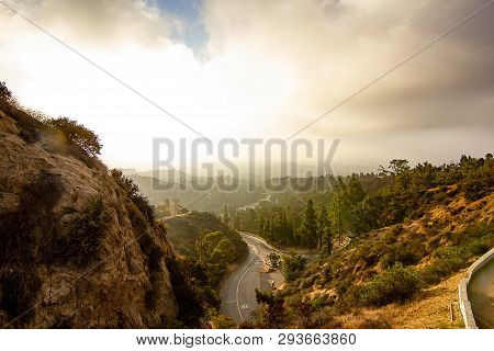 Hilside View Of Road Leading Into Hills From Below