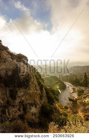 Hilside View Of Road Leading Into Hills From Below
