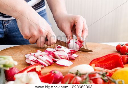 Woman Hands Cutting Vegetables On Wooden Background