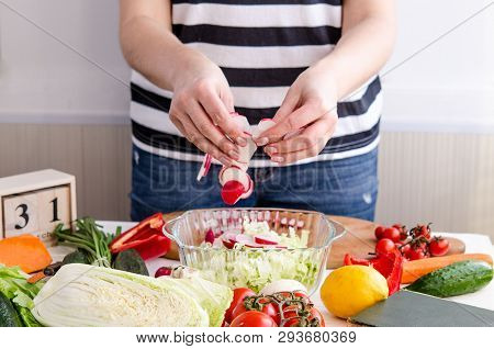 Woman Hands Adding Vegetables To Dishes