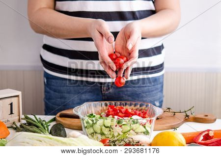 Woman Hands Adding Vegetables To Dishes