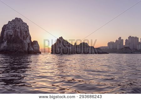 Small Silhouette Of Flying Crane At Sunset In Busan View From The Sea