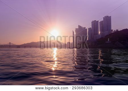 View On Busans Skyscrapers, Bridge And Park  From The Sea On Sunset
