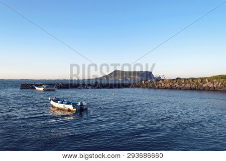 View On Sangumburi Crater With Boats In Sea Water