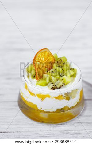 Trifle, Layered Mouse In Portioned Glass Jar. Seasonal Fresh Dessert Of Sponge Cake, Ripe Kiwi, Cust