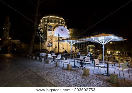 Terrace Cafe With A Pair Of Visitors In The Square Near The Synagogue Hurva At Night In The Old City