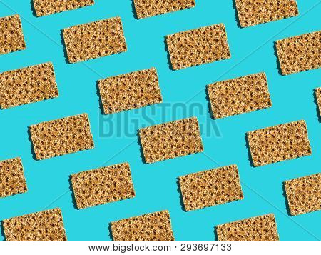 Pattern From Scandinavian Rye Whole Grain Crispbreads With Sesame Seeds On Solid Blue Background. Ha