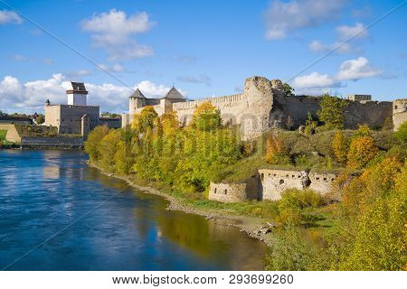View Of The Old Herman Castle And Ivangorod Fortress In The Golden Autumn. Border Of Russia And Esto