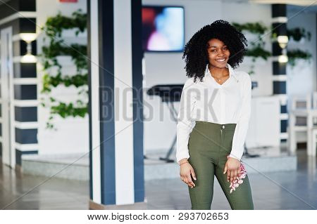 Сheerful Business African American Lady With Afro Hair, Wear White Blouse And Green Pants Posed In C