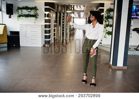 Сheerful Business African American Lady With Afro Hair, Wear White Blouse And Green Pants Posed In C