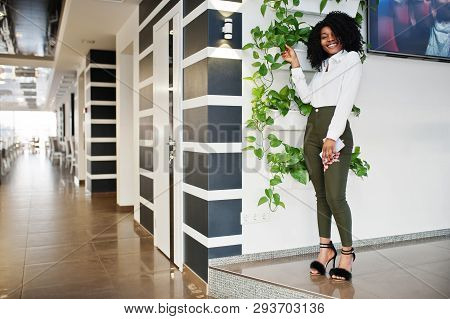 Сheerful Business African American Lady With Afro Hair, Wear White Blouse And Green Pants Posed In C