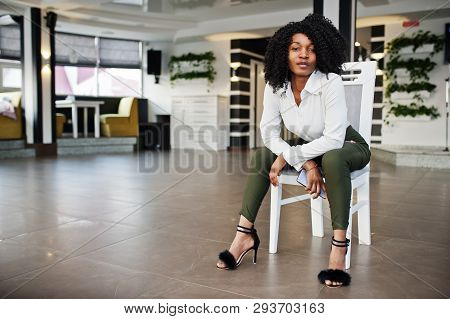 Сheerful Business African American Lady With Afro Hair, Wear White Blouse And Green Pants Posed In C