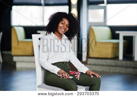 Сheerful Business African American Lady With Afro Hair, Wear White Blouse And Green Pants Posed In C