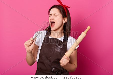 Happy Singing Baker Wears Kitchen Apron Smeared With Flour, White T Shirt, Red Headband, Holds Bakin