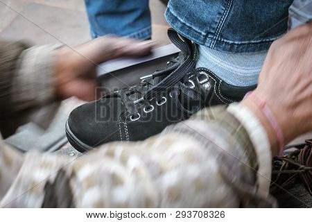 Street Shoe Shine. Brushing Brush Your Black Shoes With Black Cream.