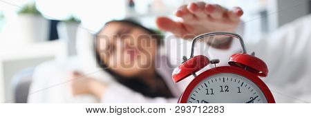 Sleepy Young Woman Portrait With One Opened Eye Trying Kill Alarm Clock. Early Wake Up Not Getting E