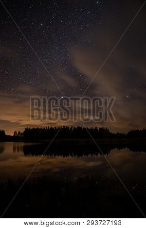 Night Sky With Starts In A  Conemara Lake With Pine Forest Around