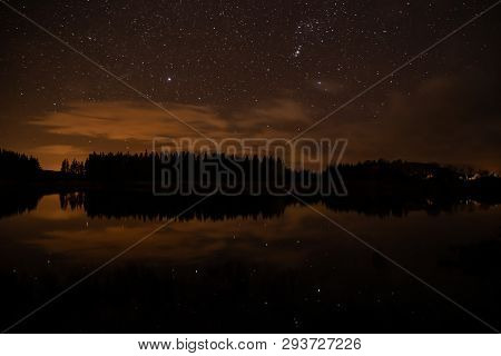 Night Sky With Starts In A  Conemara Lake With Pine Forest Around