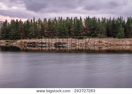 Sunset In Conemara Lake With Pine Forest Around