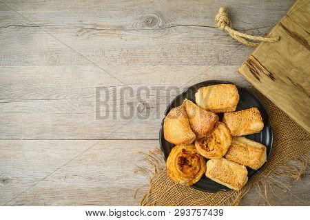 Burekas Filled With Cheese, Potato And Pizza Rolls On Wooden Table. Top View From Above