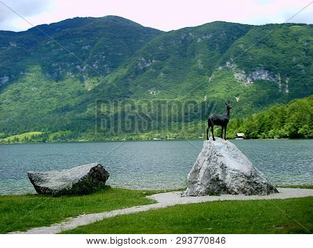 The Statue Of Goldhorn By The Lake Bohinj In Triglav National Park. Slovenia