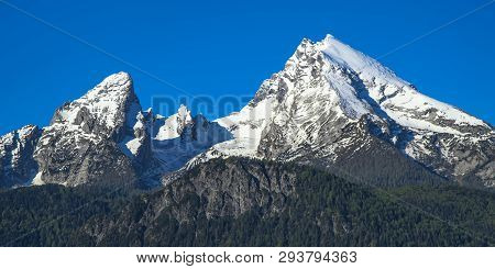 Panoramic View Of Spring Snow-capped Peaks Of Watzmann Mountain In Bavarian National Park Berchtesga