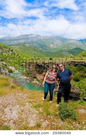 Couple at the wild river bank