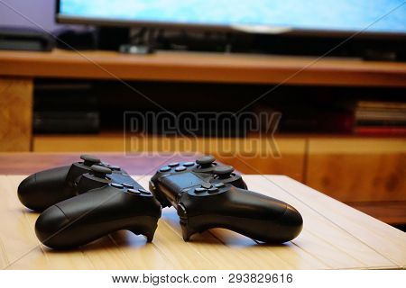 22.03.2019 Eskisehir, Turkey. Two Ps4 Gamepads On Wooden Background Close Up View