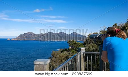 A Tourist Uses Binoculars To Enjoy The View From Cape Tourville