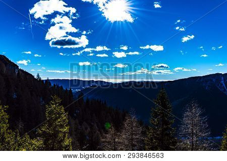 Sunny Day In Asiago, With Clouds And Blue Sky In The Italian Alps