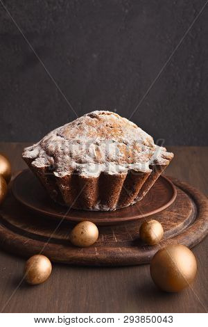 Easter Background With Cake And Golden Eggs On Wooden Table