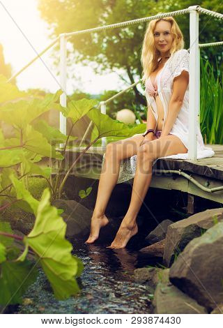 Youmg Beautiful Blond Woman In Beautiful Summer Garden
