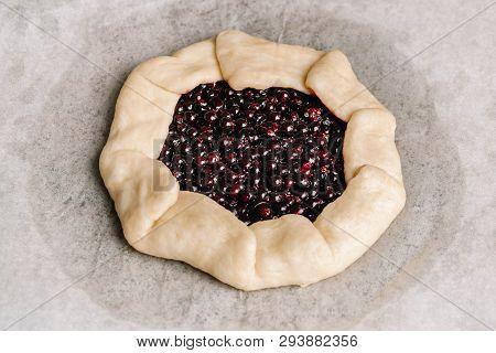 Homemade Galette Pie With Red And Black Currants, Blueberries And Raspberries On Wooden Background.