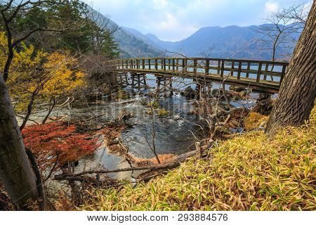 Old Wooden Bridge With Leaves Turning Color In Yuno Lake - Nikko, Japan