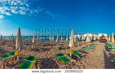 Morning Paradise White Sandy Beach With Sunshades And Sunbeds (salento, Puglia, South Italy). The Mo