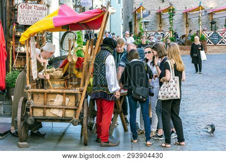 Tallinn, Estonia, August 9: Tourists Get Acquainted With Local Cuisine On The Town Hall Square Of Ta