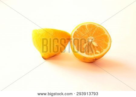 Lemon, Cut Into Two Parts, Lies On A White Background