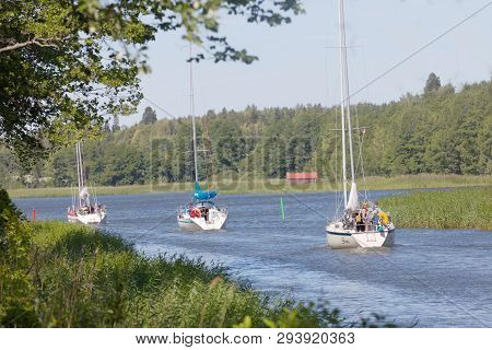 Almsta, Sweden - Jul 09 2018: Several Sailships On A Narrow Canal Vaddo Kanal Through The Forest. Ju
